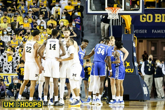 Caleb Houstan (22), Moussa Diabate (14), Hunter Dickinson (1), and DeVante' Jones (12)