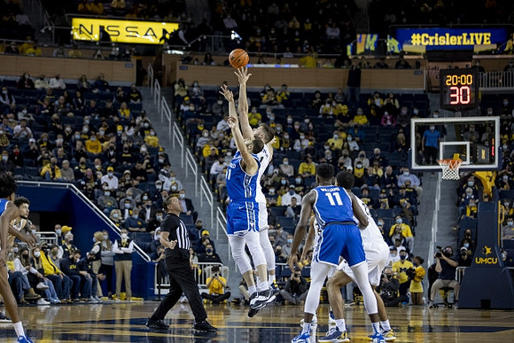 Brandon Johns Jr. (23), Hunter Dickinson (1), and Caleb Houstan (22)