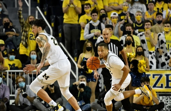 Brandon Johns Jr. (23) and DeVante' Jones (12)