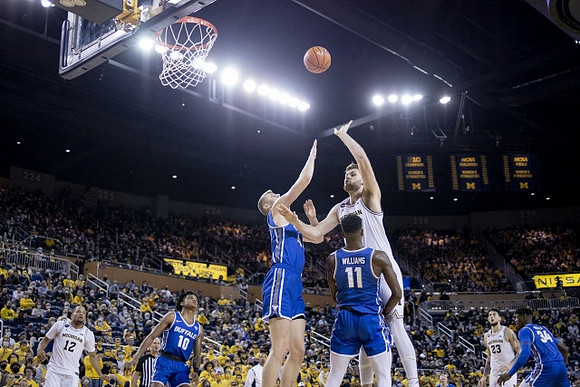 DeVante' Jones (12), Hunter Dickinson (1), and Brandon Johns Jr. (23)