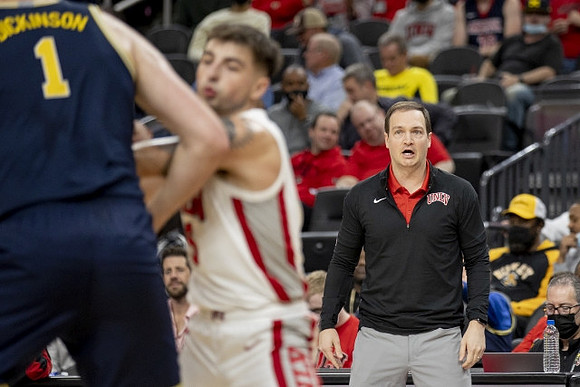 Hunter Dickinson (1) and UNLV Head Coach Kevin Kruger