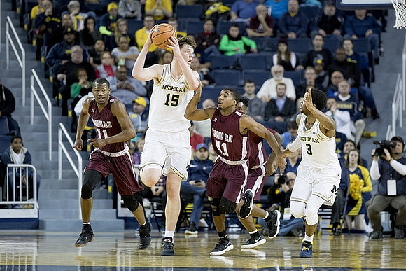Moritz Wagner (13) and Zavier Simpson (3)