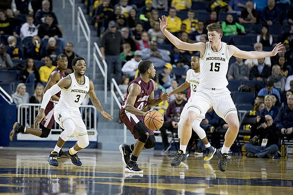 Zavier Simpson (3), Muhammad-Ali Abdur-Rahkman (12), and Jon Teske (15)