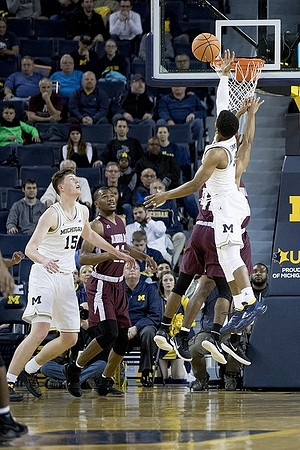 Jon Teske (15) and Zavier Simpson (3)