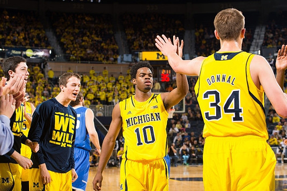 Sean Lonergan (20), Andrew Dakich (11), Derrick Walton Jr. (10), and Mark Donnal (34)