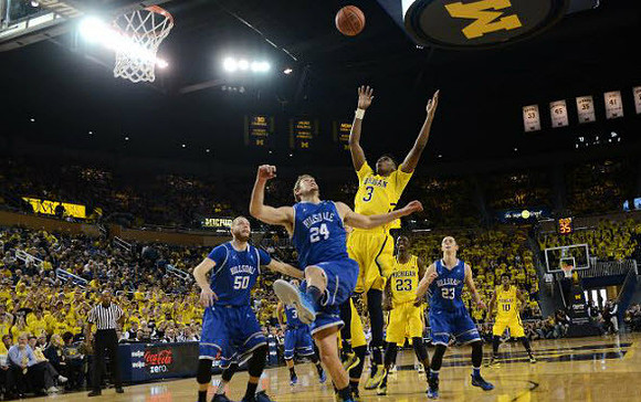 Kameron Chatman (3), Caris LeVert (23), and Derrick Walton Jr. (10)