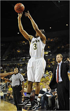 Trey Burke (3) and Fred Hoiberg