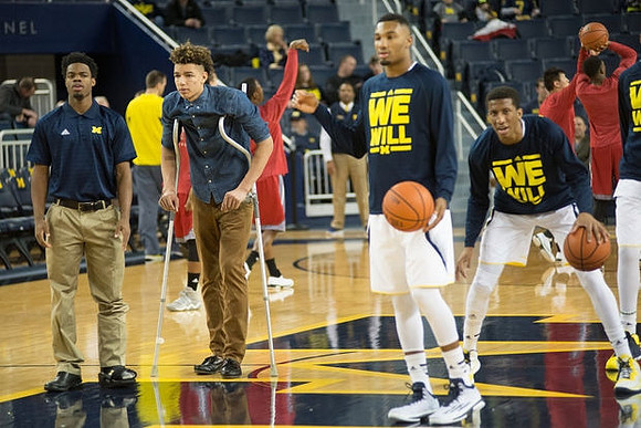 Derrick Walton Jr. (10), D.J. Wilson (5), Zak Irvin (21), and Aubrey Dawkins (24)