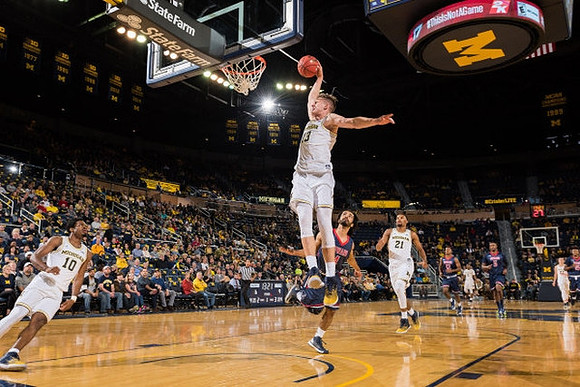 Derrick Walton Jr. (10), Moritz Wagner (13), and Zak Irvin (21)
