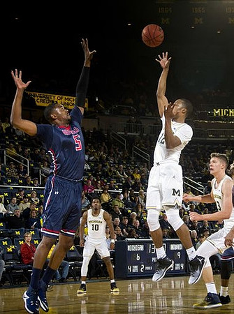 Derrick Walton Jr. (10), Muhammad-Ali Abdur-Rahkman (12), and Moritz Wagner (13)