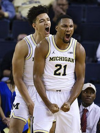 D.J. Wilson (5) and Zak Irvin (21)