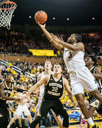 Zavier Simpson (3), Jon Teske (15), and Ignas Brazdeikis (13)