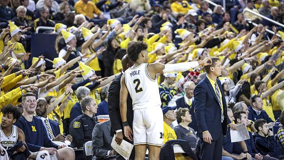 Jordan Poole (2), Luke Yaklich, and Michigan Team
