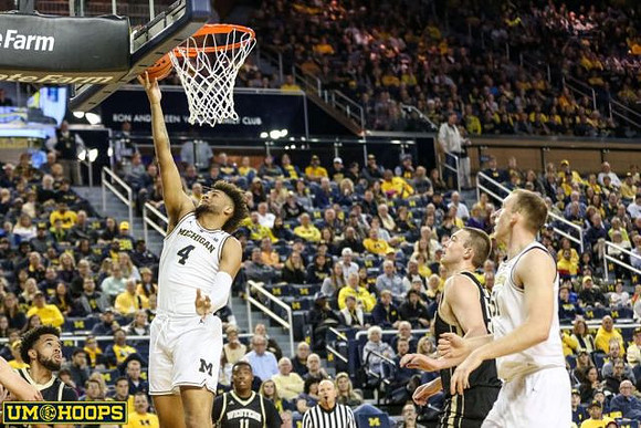 Isaiah Livers (4) and Austin Davis (51)