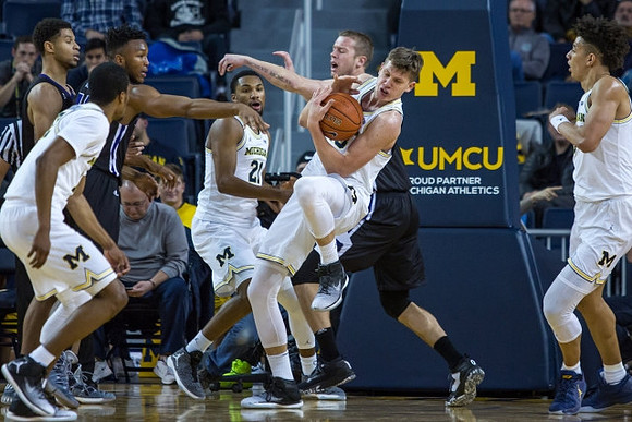 Muhammad-Ali Abdur-Rahkman (12), Zak Irvin (21), Moritz Wagner (13), and D.J. Wilson (5)