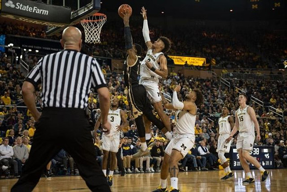 Zavier Simpson (3), Jordan Poole (2), Isaiah Livers (4), Charles Matthews (1), and Jon Teske (15)