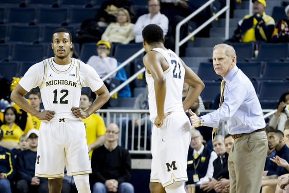 Muhammad-Ali Abdur-Rahkman (12), Zak Irvin (21), and John Beilein