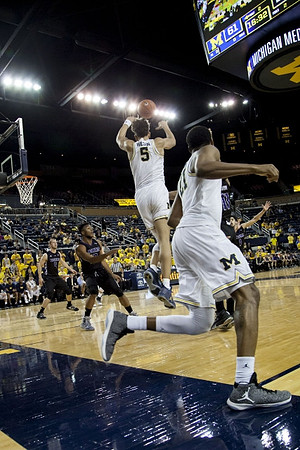 D.J. Wilson (5) and Zak Irvin (21)