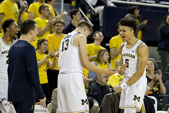 Zak Irvin (21), Andrew Dakich (11) , Moritz Wagner (13), and D.J. Wilson (5)