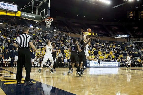 Mark Donnal (34), D.J. Wilson (5), and Xavier Simpson (3)