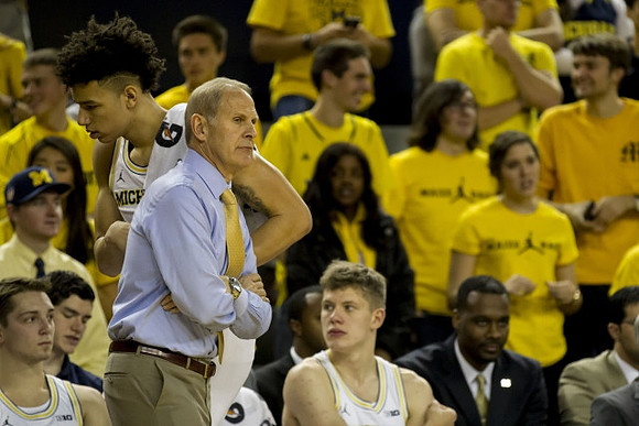 Mark Donnal (34), D.J. Wilson (5), John Beilein, and Moritz Wagner (13)
