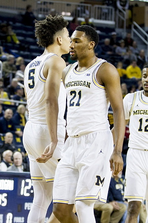 D.J. Wilson (5), Zak Irvin (21), and Muhammad-Ali Abdur-Rahkman (12)