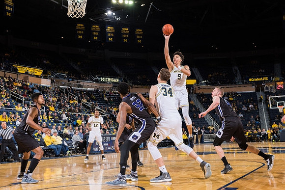 Mark Donnal (34), D.J. Wilson (5), and Brent Hibbitts (0)