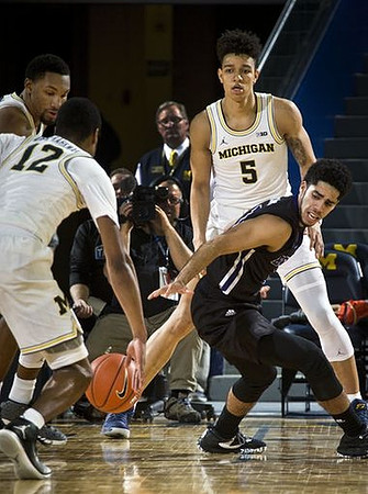 Zak Irvin (21), Muhammad-Ali Abdur-Rahkman (12), and D.J. Wilson (5)