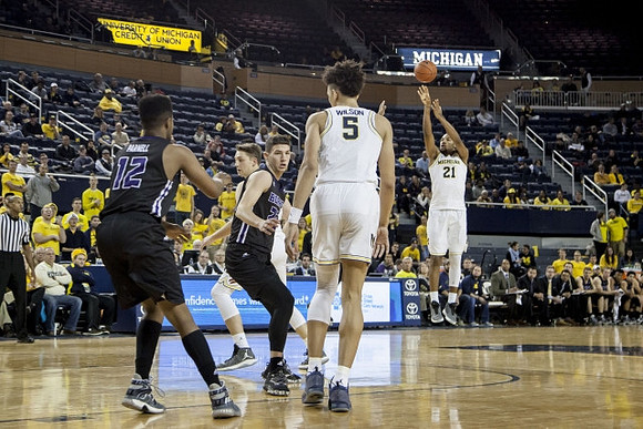 D.J. Wilson (5) and Zak Irvin (21)