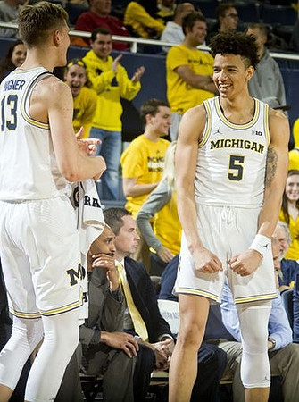 Moritz Wagner (13) and D.J. Wilson (5)
