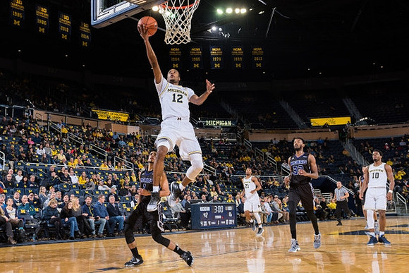 Muhammad-Ali Abdur-Rahkman (12), Zak Irvin (21), and Derrick Walton Jr. (10)