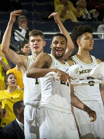 Moritz Wagner (13), Zak Irvin (21), and D.J. Wilson (5)