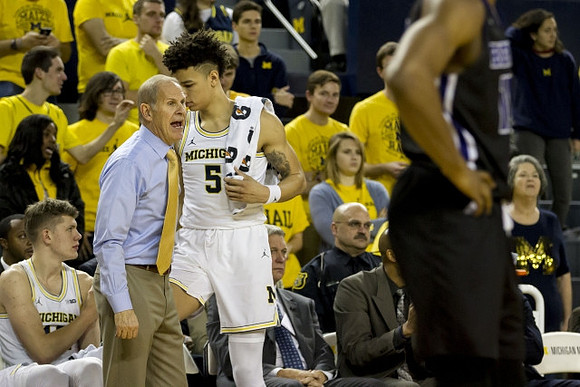 Moritz Wagner (13), John Beilein, and D.J. Wilson (5)