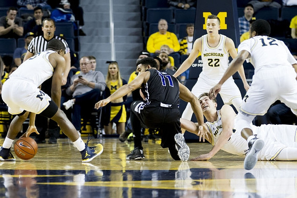 Xavier Simpson (3), Duncan Robinson (22), Mark Donnal (34), and Muhammad-Ali Abdur-Rahkman (12)
