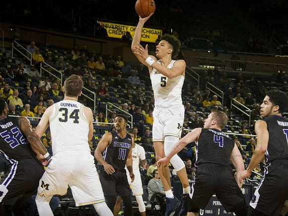 Mark Donnal (34) and D.J. Wilson (5)