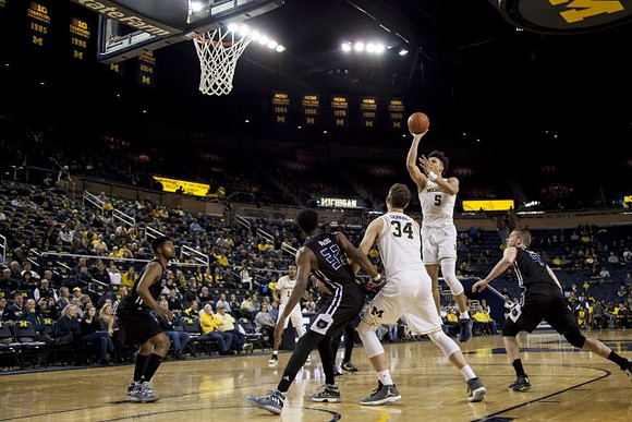 Mark Donnal (34) and D.J. Wilson (5)