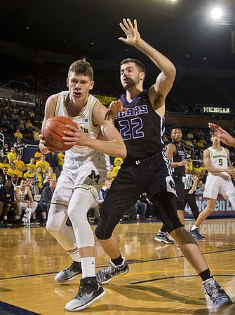 Moritz Wagner (13) and D.J. Wilson (5)