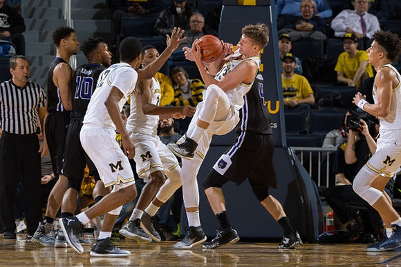 Muhammad-Ali Abdur-Rahkman (12), Zak Irvin (21), Moritz Wagner (13), and D.J. Wilson (5)