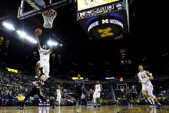 Muhammad-Ali Abdur-Rahkman (12), Zak Irvin (21), Derrick Walton Jr. (10), and D.J. Wilson (5)