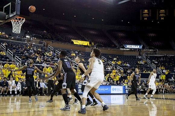 D.J. Wilson (5) and Zak Irvin (21)