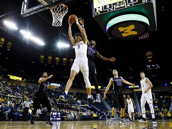 D.J. Wilson (5), Derrick Walton Jr. (10), and Moritz Wagner (13)