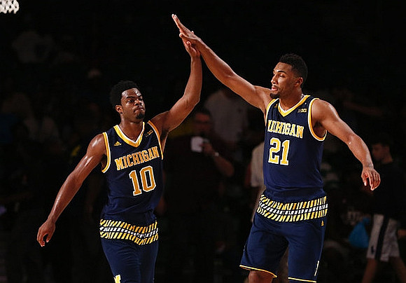 Derrick Walton Jr. (10) and Zak Irvin (21)