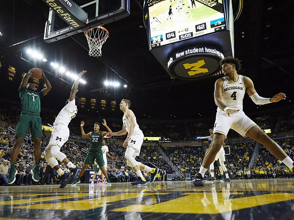 Zavier Simpson (3), Moritz Wagner (13), and Isaiah Livers (4)