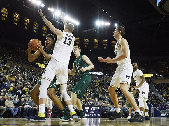 Moritz Wagner (13), Duncan Robinson (22), and Zavier Simpson (3)