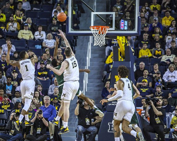 Charles Matthews (1), Jon Teske (15), and Isaiah Livers (4)