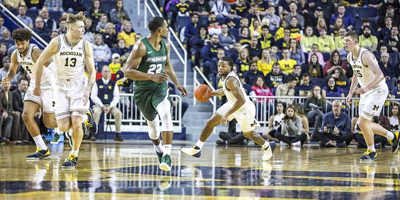 Isaiah Livers (4), Ignas Brazdeikis (13), Zavier Simpson (3), and Jon Teske (15)
