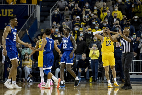 Eli Brooks (55) and DeVante' Jones (12)