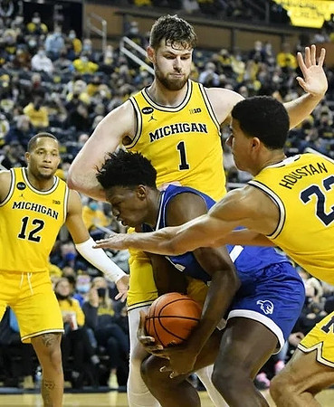 DeVante' Jones (12), Hunter Dickinson (1), and Caleb Houstan (22)