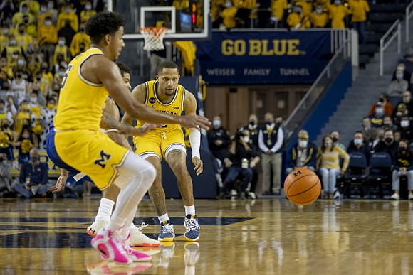Eli Brooks (55) and DeVante' Jones (12)