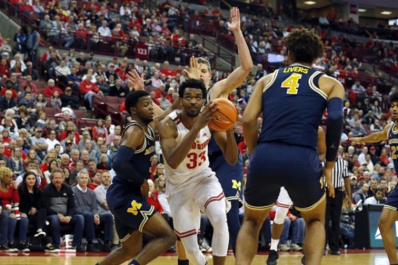 Zavier Simpson (3), Moritz Wagner (13), and Isaiah Livers (4)